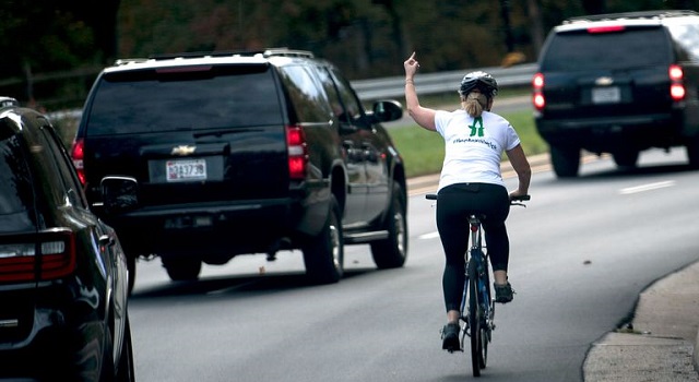 Juli Briskman gives the PotUS the one finger salute